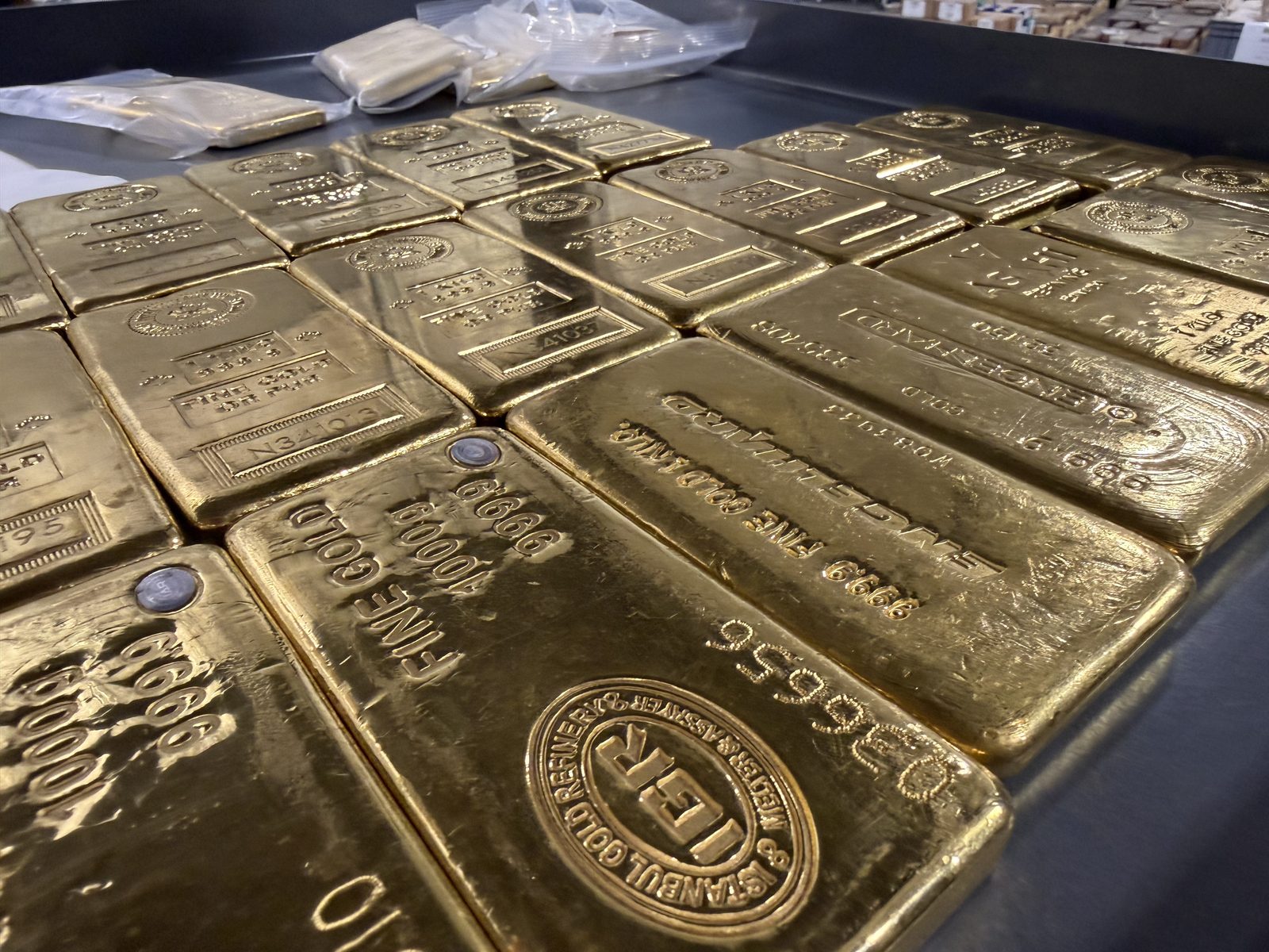 Rows of gold bars stored in a secure, insured depository