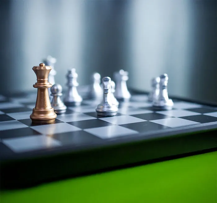 Gold and silver chess pieces on a board, representing control over when to buy and sell