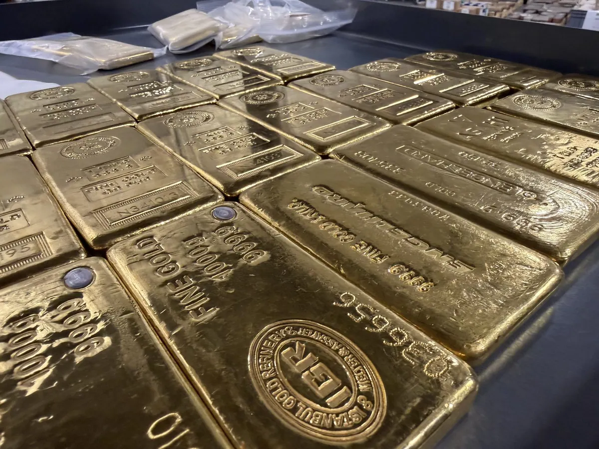 Rows of gold bars stored in a secure, insured depository