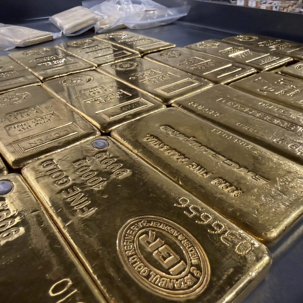 Rows of gold bars stored in a secure, insured depository