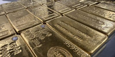 Rows of gold bars stored in a secure, insured depository